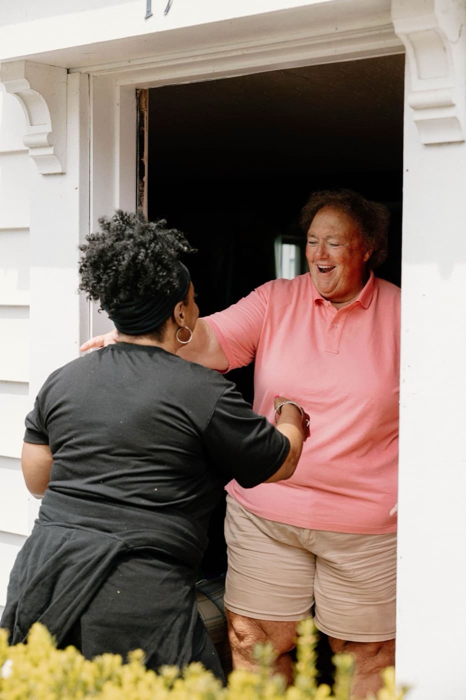 She Does Hauling founder hugging a happy customer in her doorway