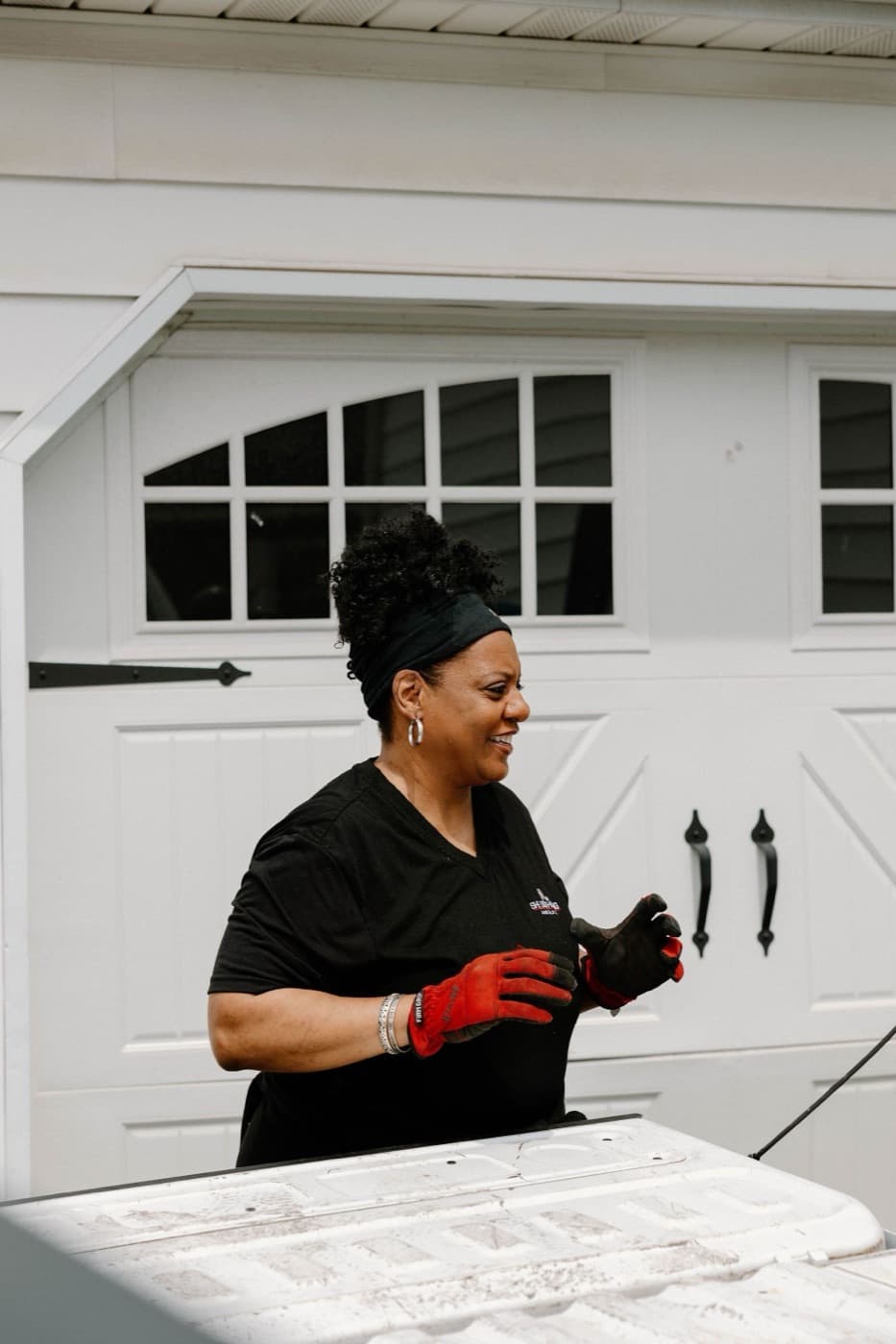 She Does Hauling founder in red work gloves working a junk removal job