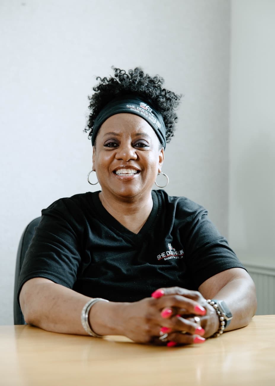 Maria B. Williams-Turner, MBA — Founder and CEO of She Does Hauling, at her desk
