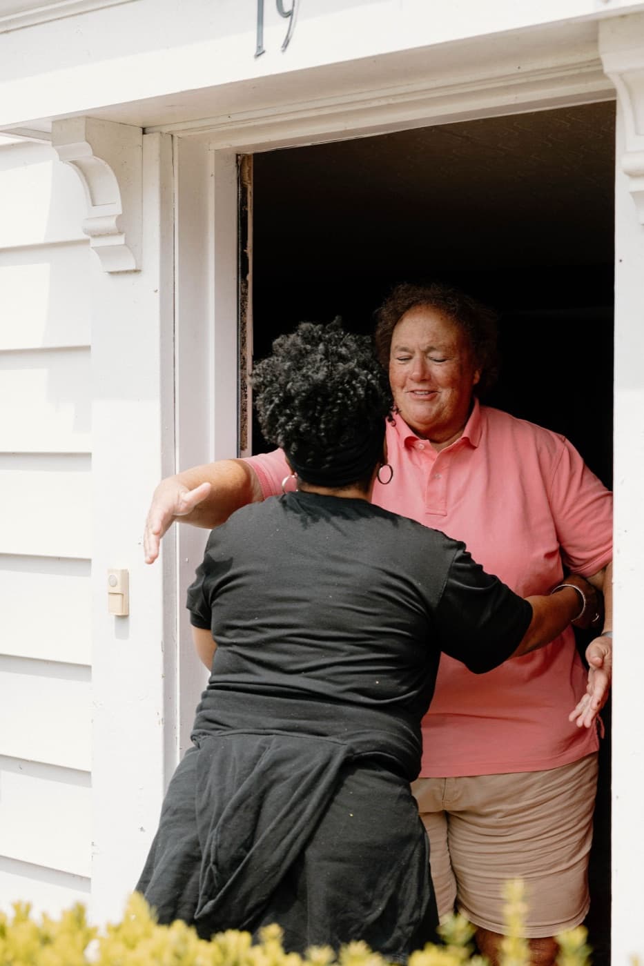 A She Does Hauling crew member hugging a happy customer after a successful junk removal job
